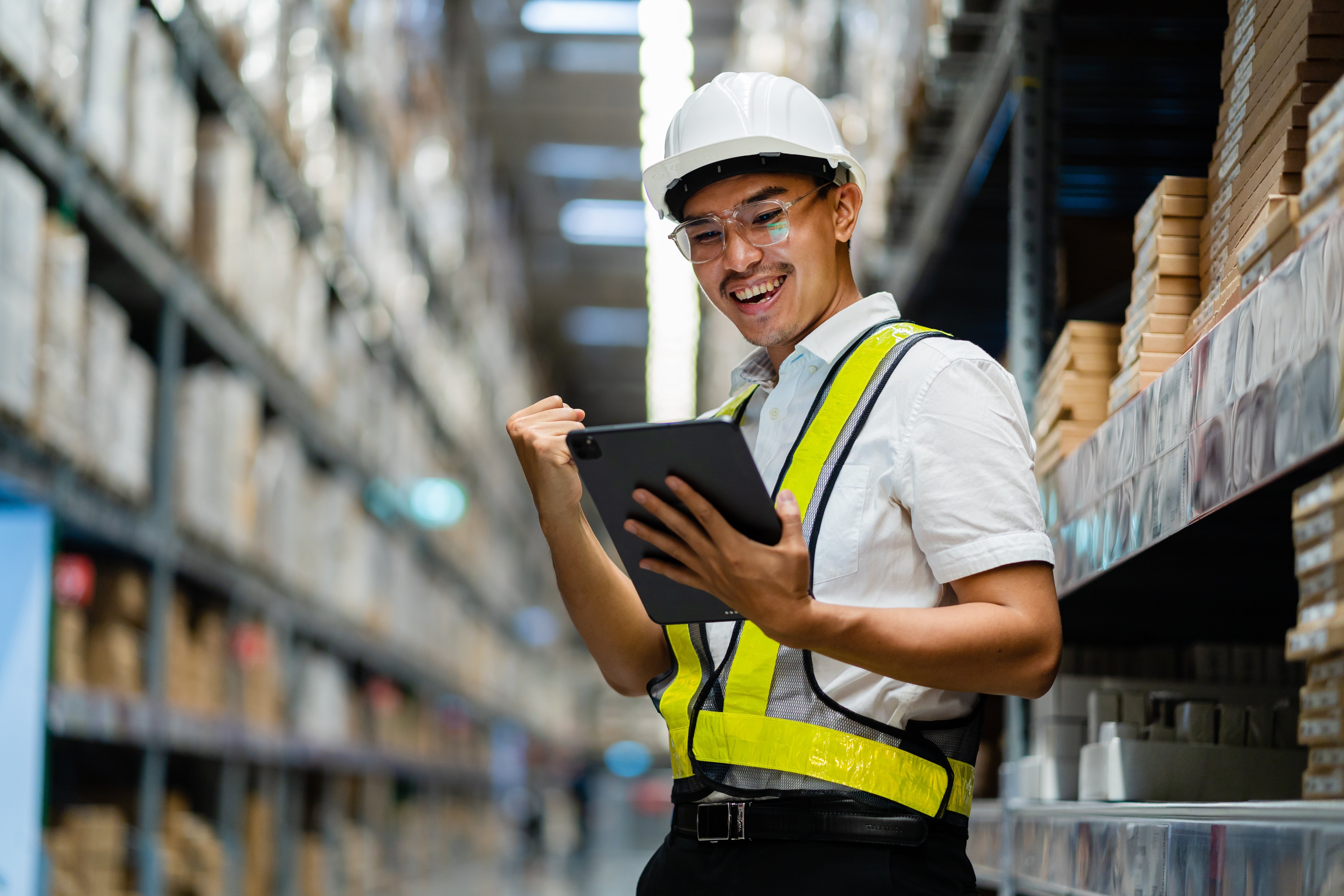 Warehouse Worker Smiling Holding Tablet (1)